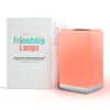 One FriendLi Friendship Lamps in orange colors, with a product box in the background, both on a white background.