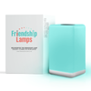 A teal-colored FriendLi Friendship Lamp with a visible power base, alongside its packaging box which features the product name and website.