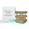 Natural Friendship Lamps with mini mid-century modern design, featuring knotty alder wood and brushed aluminum, displayed alongside its packaging box.