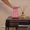 Woman touching a Friendship Lamp to light her partner’s lamp across the world