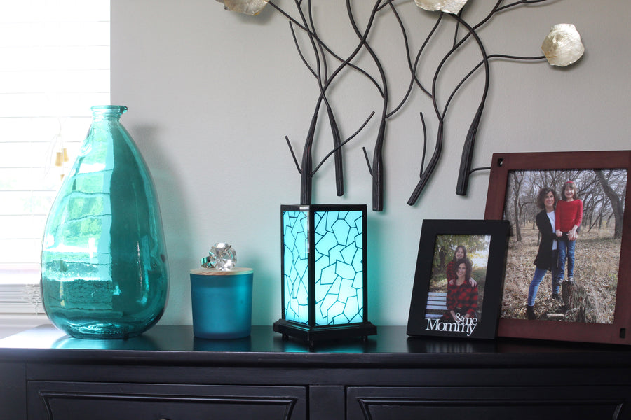[Friendship Lamp Classic teal on counter with pictures]